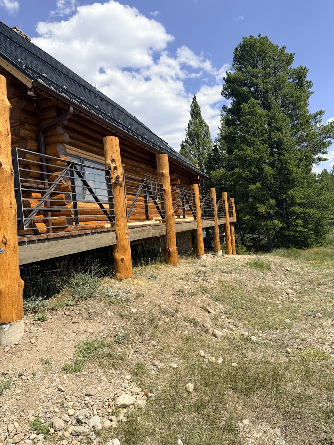 Rustic cabin deck with custom steel railing by AR Custom Metal Works