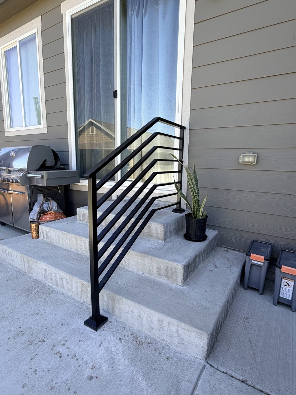 Modern black exterior stair handrail by AR Custom Metal Works