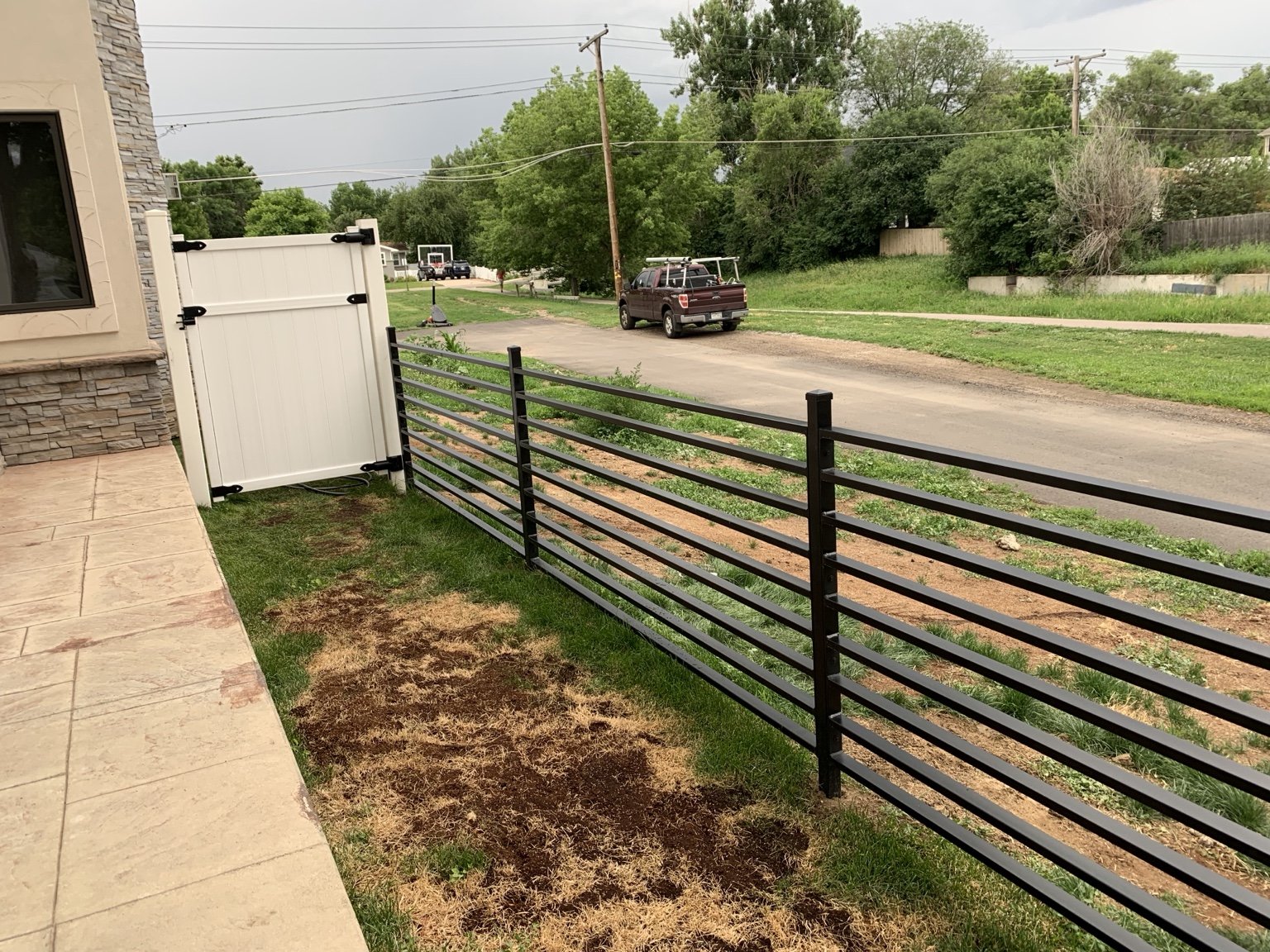 Modern horizontal steel fence detail by AR Custom Metal Works