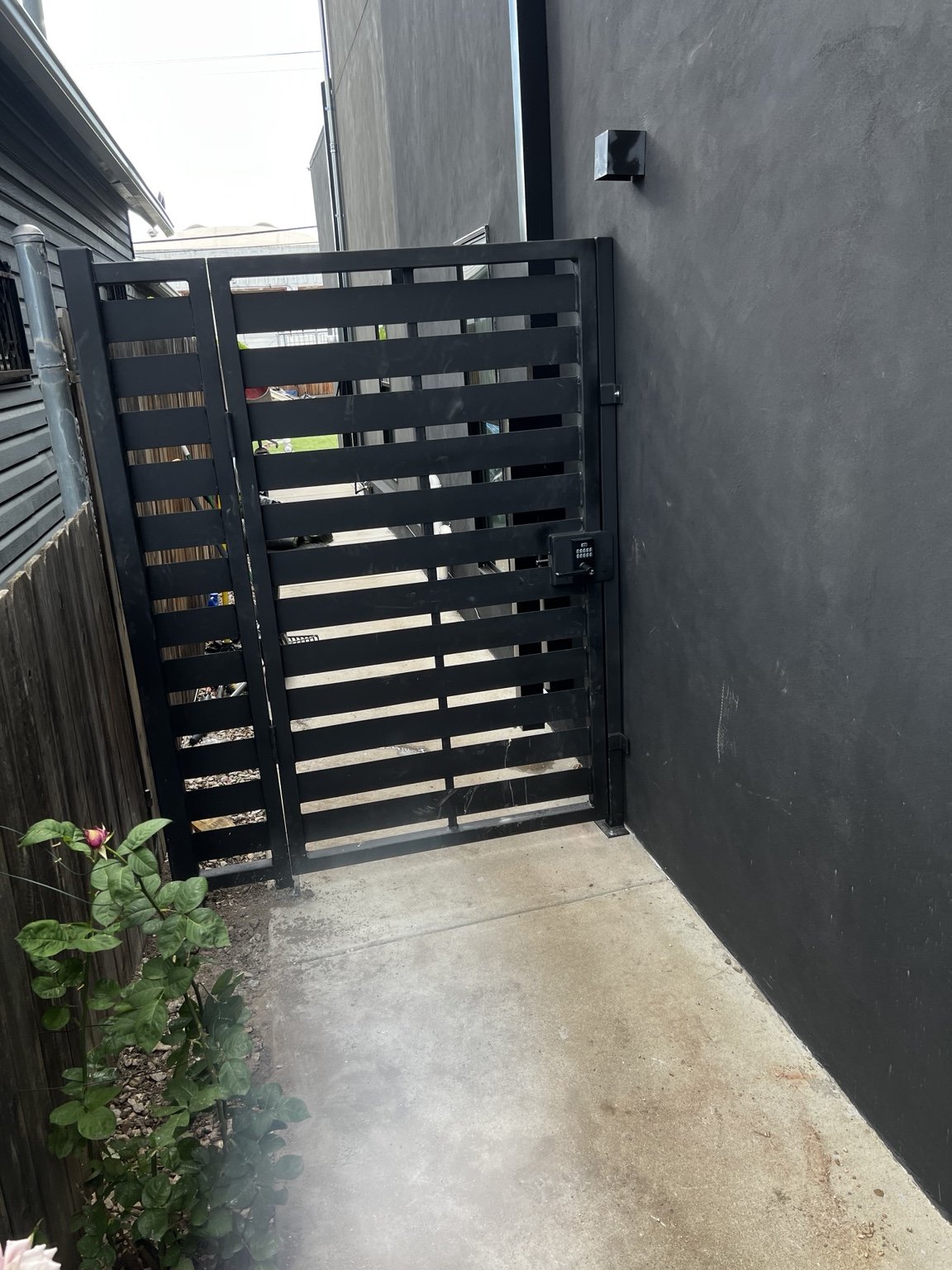 Modern steel privacy gate with keypad by AR Custom Metal Works