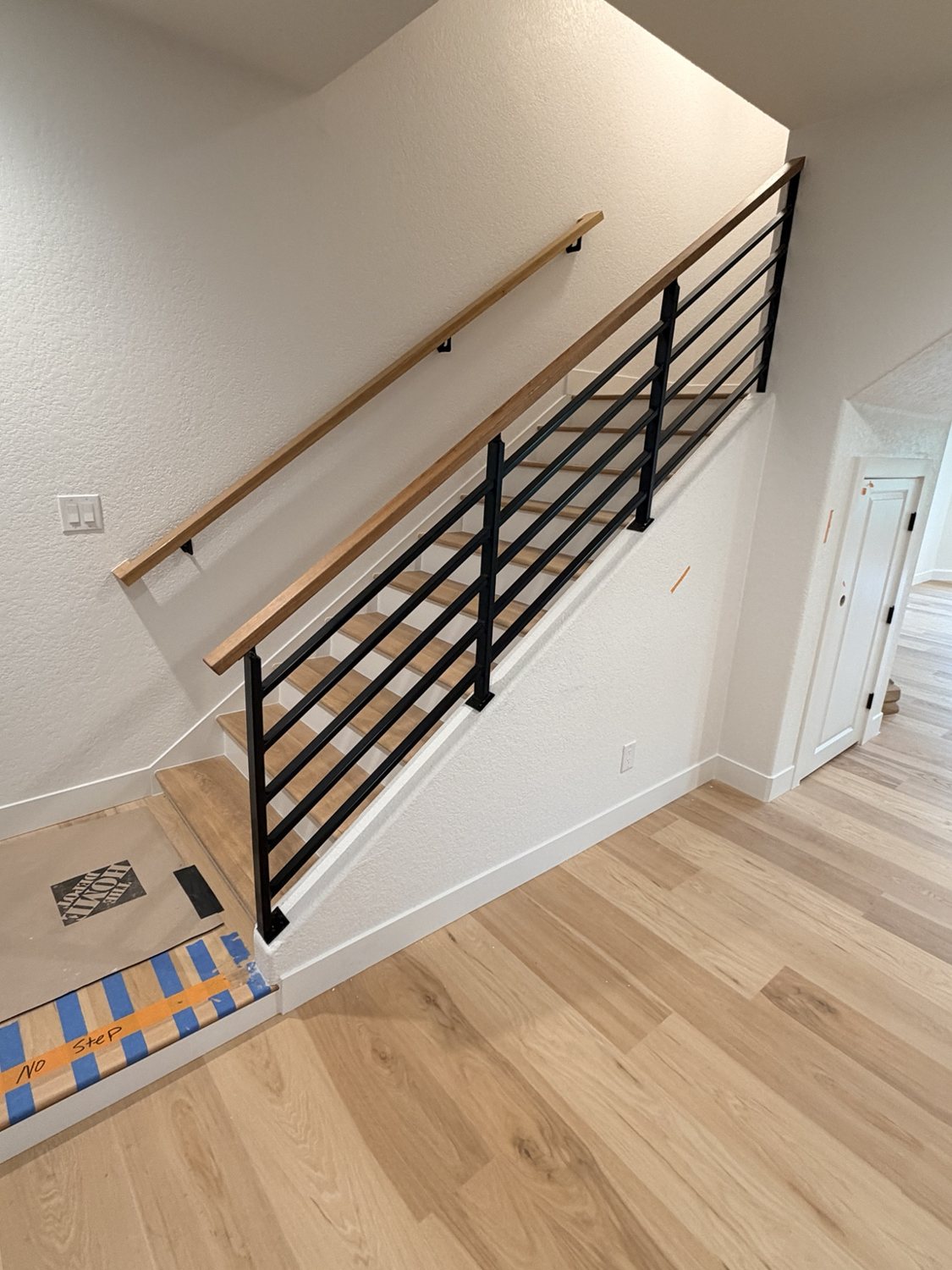 Modern steel stair railing with wood handrail by AR Custom Metal Works