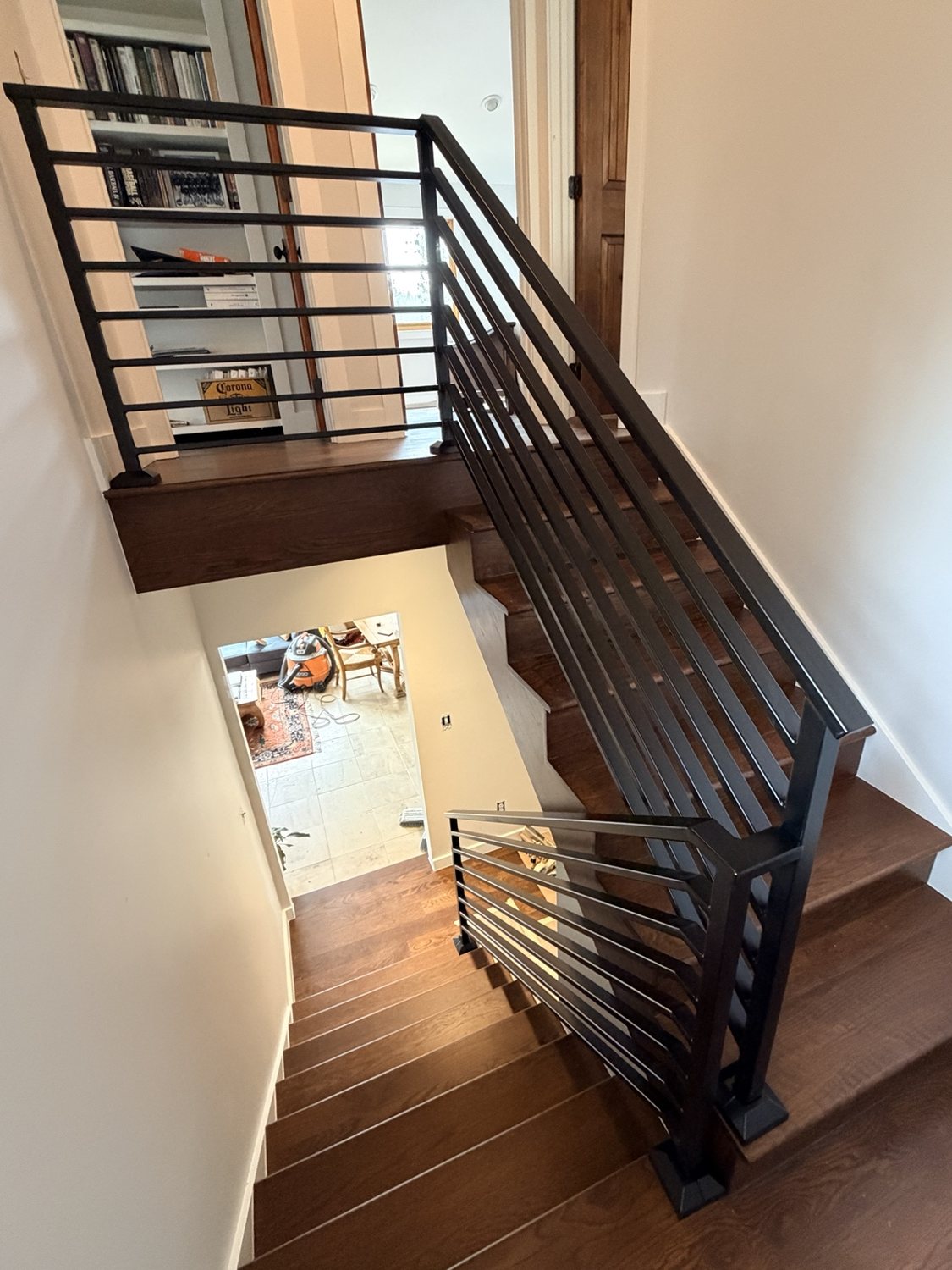 Custom black stair railing installation by AR Custom Metal Works